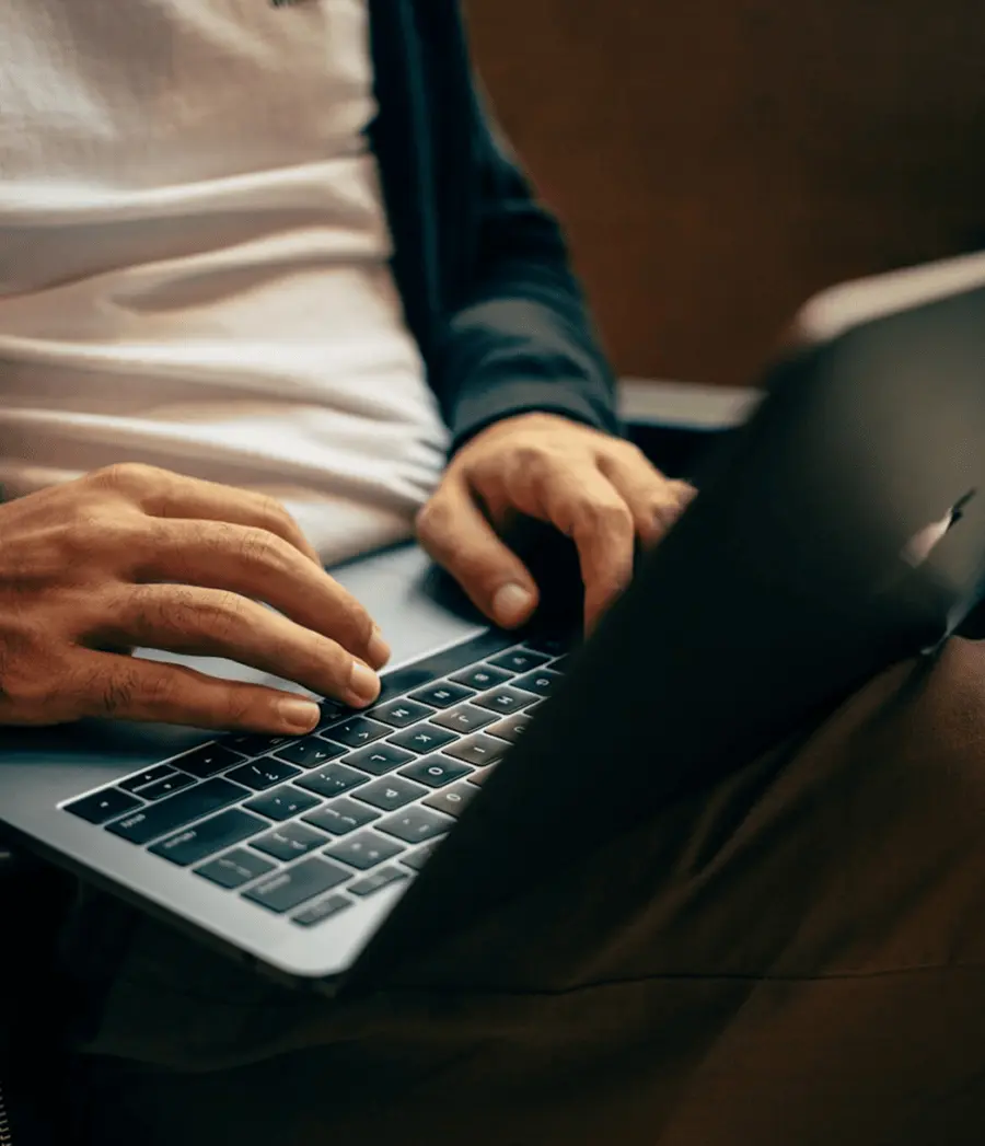 Person typing on the laptop